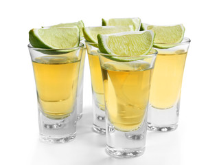 Shots of gold tequila with lime slices isolated on white © Africa Studio