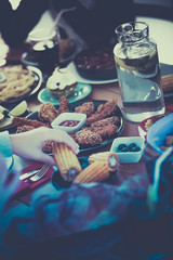 Top view of group of people having dinner together while sitting at wooden table
