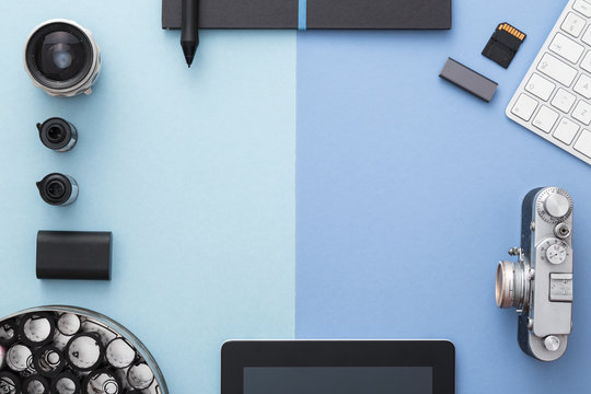 Photographer's Desk In Blue With Vintage Camera, Rolls Of Film And Keyboard. Stylish And Elegant. Top View.