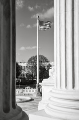 Flag flying between two pillars of the Supreme Court of the Unit
