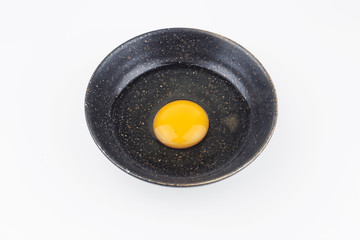 One egg yolks in black bowl