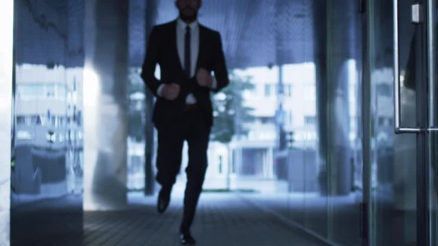 Businessman Running on Streets of Business District. Slow Motion Shot. Shot on RED Cinema Camera in 4K (UHD).