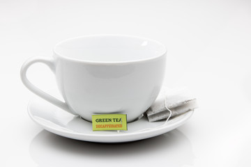 Cup and saucer with a bag of Green Tea