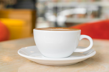 Coffee cup on table in cafe .