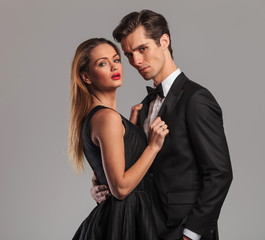 closeup picture of an elegant couple standing embraced