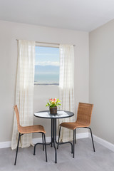 A round breakfast table with two chairs.