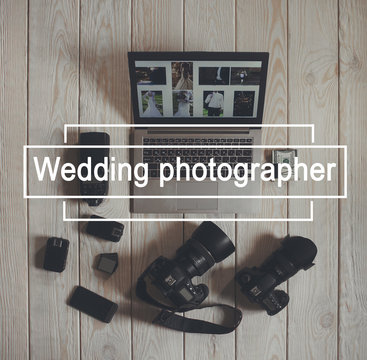 Wedding photographer work tools flat lay. Top view on photo cameras with equipment, smartphone, bundle of money and laptop with wedding photos on light wooden background.