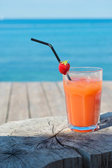 Orange cocktail on the wooden table