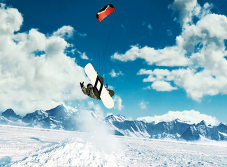 Young men, ride snowboarding on frozen lake in the mountains, in the rays of the rising sun, in...