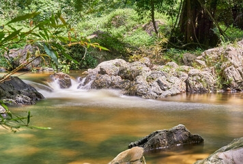 Naklejka na ściany i meble A little waterfall in the tropical rain forest