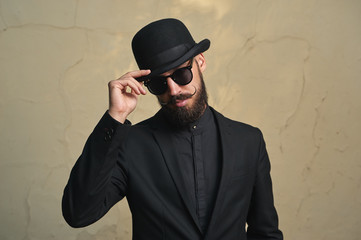 Fototapeta na wymiar Bearded Man with black Clothes greets
