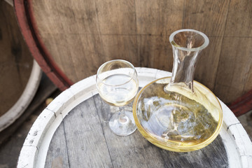 Bottle of wine with wine glass on the runlet. White wine.