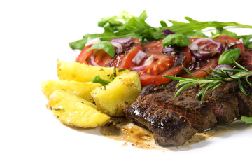 roasted beef filet mignon with potatoes and tomato arugula salad isolated on white