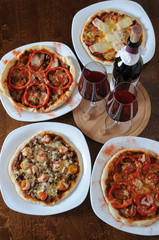 Pizza and wine on a wooden background