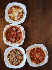 Pizza on a wooden background with free field