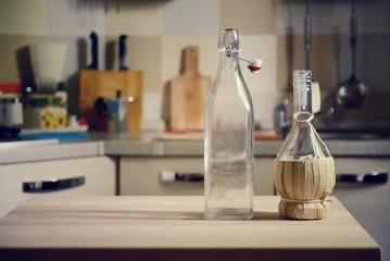 bottles on wooden table on kitchen  background