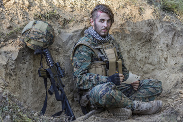 Soldier on the ground with gun