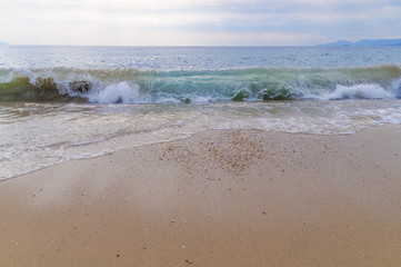 Big wave on sea with beach background