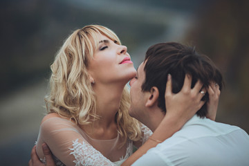 Closeup portrait of young gorgeous bride and groom