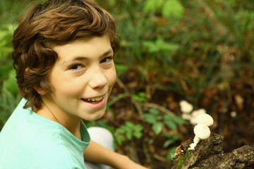 boy in the forest with puffball mushrooms