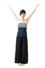 Pretty happy short hair woman shaping letter V with her arms. Full body length portrait isolated over white studio background.