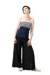 Tender feminine short hair woman in off the shoulder top looking up. Full body length portrait isolated over white studio background.