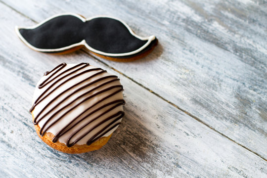 Glazed biscuit and moustache cookie. Pastry on gray background. Taste and design. Delicious sweets with icing. - Powered by Adobe