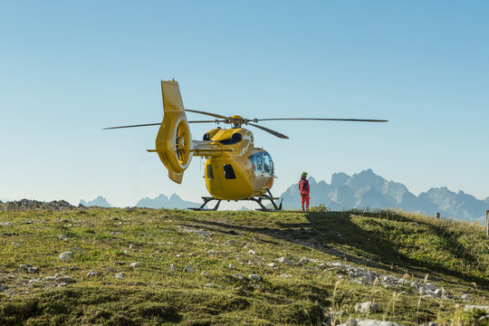 Yellow helicopter used for rescue operations, On the ground in Dolomites, Italy. Helicopter rescue