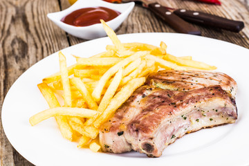 Loin Roast with Potatoes Fries on White Plate