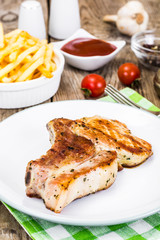 Loin Roast with Potatoes Fries on White Plate