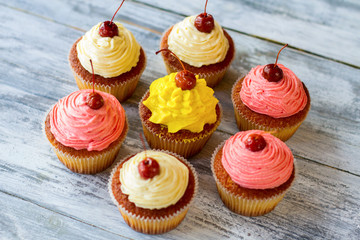 Cupcakes with icing. Desserts on gray background. Sweet treats made at home. Fresh ingredients and simple recipe.