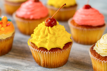 Bright frosted cupcake. Red berry and yellow icing. Easy recipe of good mood. Find new colors in life.