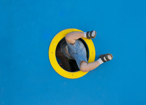 Funny Kid Playing In The Playground.