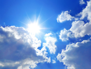 Naklejka na ściany i meble Sunbeam and blue sky with fluffy clouds, sky scene.