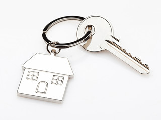 keychain house key metal white background. concept dwelling property rental