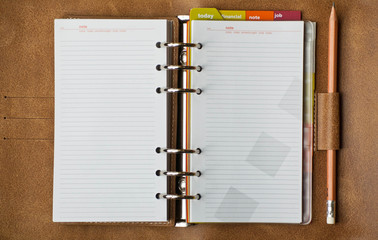 Business concept - personal organizer and pencil