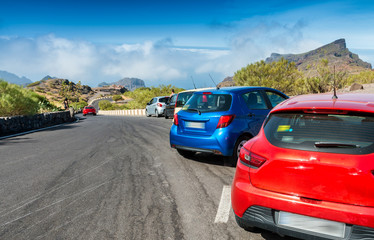 Fototapeta na wymiar Colourful cars parked on a mountain road