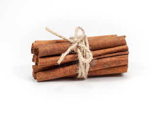 Tied bunch of cinnamon sticks isolated on white background