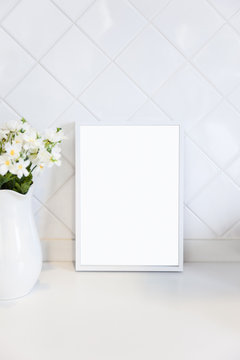 Mock up Blank Photo Frame on white tile wall with flower Home decoration