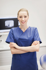 happy female dentist at dental clinic office