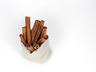 Bunch of cinnamon in canvas bag isolated on white background