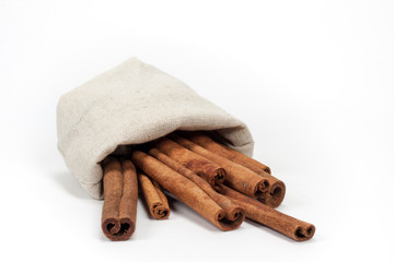 Bunch of cinnamon in canvas bag isolated on white background