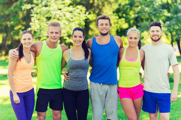 group of happy friends or sportsmen outdoors