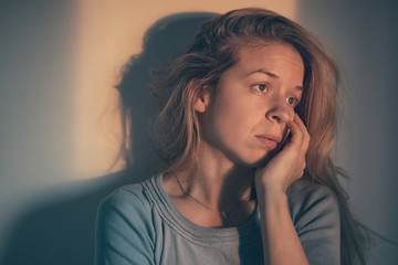 A woman sitting alone and depressed

