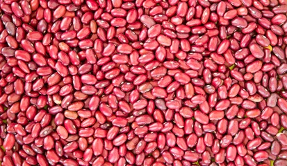 Schilderijen op glas Red kidney bean texture background. Also called Rajma or Mexican Bean. A large, kidney-shaped bean with a subtle sweet flavor and soft texture that keep their shape during cooking. © MediaNation.online