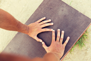 close up of man hands exercising on bench outdoors