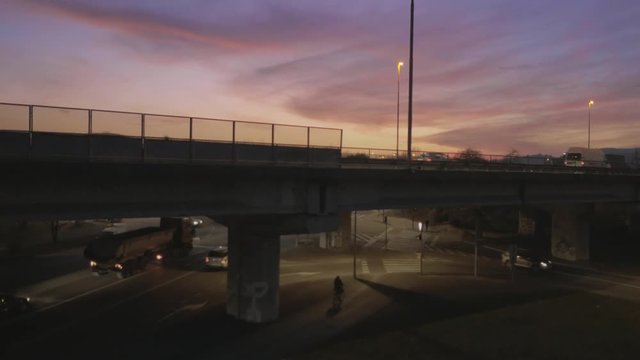 Aerial, vertical lift over freeway at sunset, sunrise
