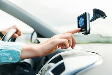 close up of man with gadget on screen driving car