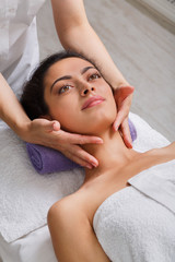 Fototapeta na wymiar Woman beautician doctor make face massage in spa wellness center