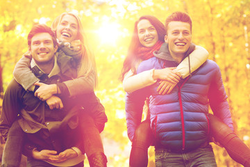 smiling friends having fun in autumn park